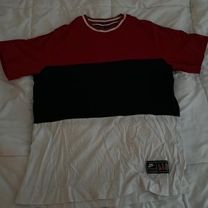 Red, black, and white Nike shirt.